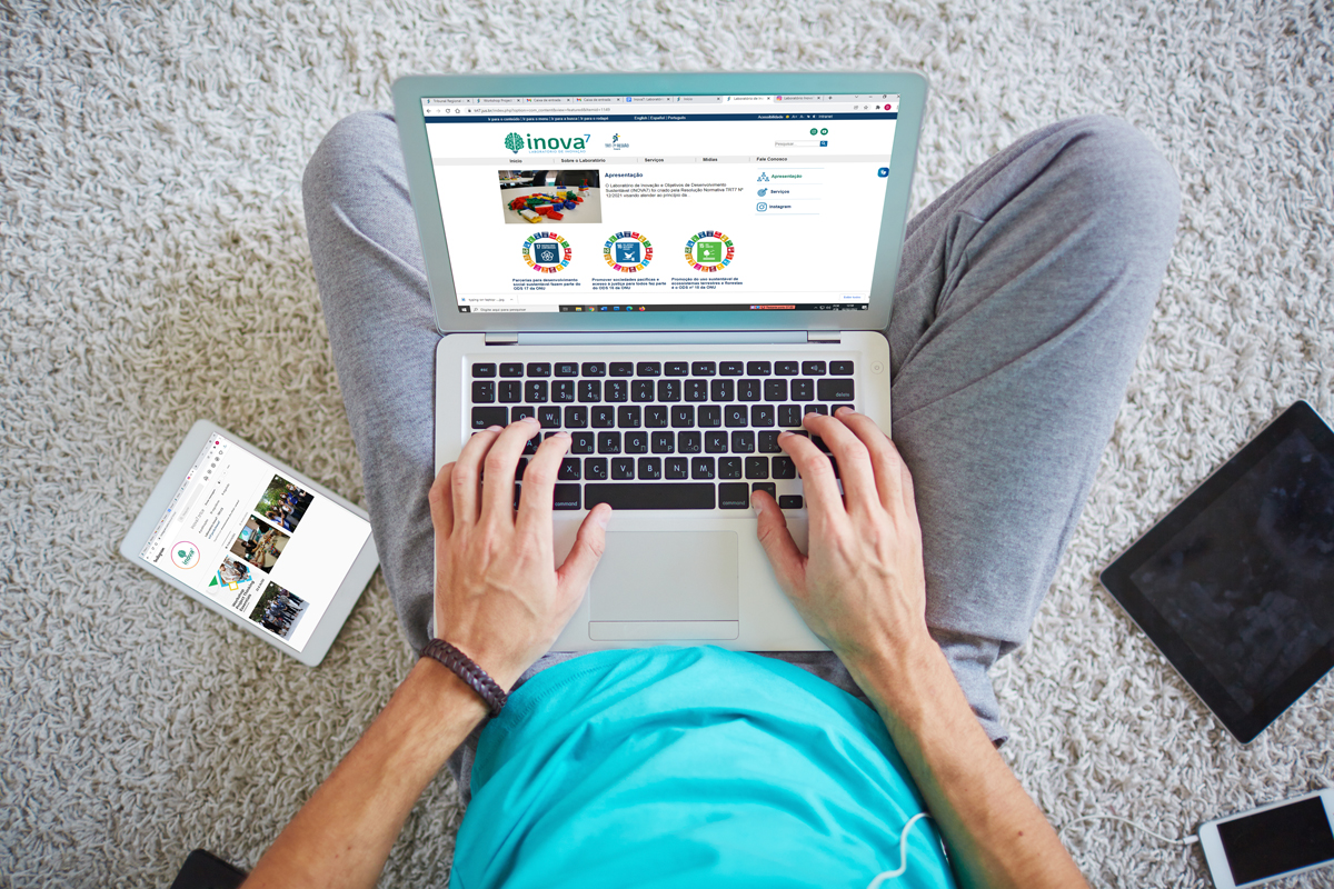 Vista de cima de uma pessoa acessando o site do Inova7 pelo laptop